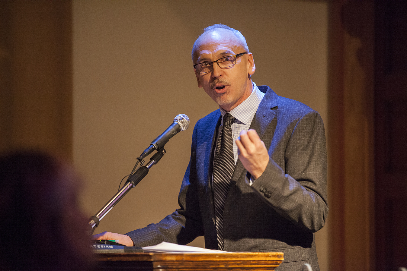 Gordon Pepper in formal wear giving a lecture.